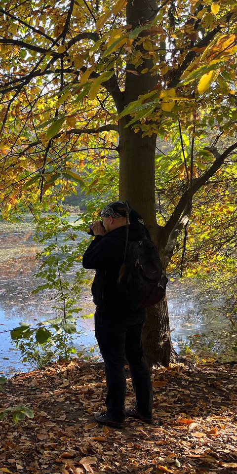 Biography: Zouberi taking a photo in nature